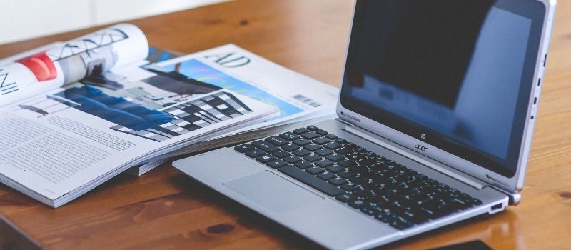 13 Places to promote affiliate links - a laptop and a magazine on a table