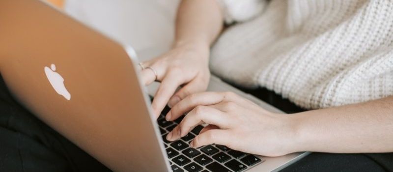 A lady on sofa using a laptop 1